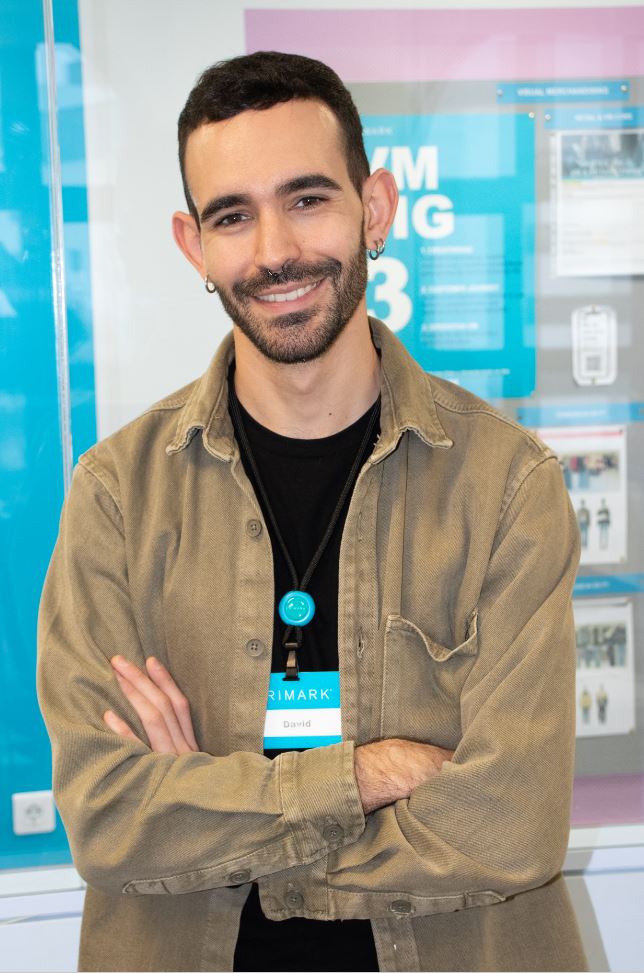 Male colleagues standing in office in Primark store with arms crossed and smiling