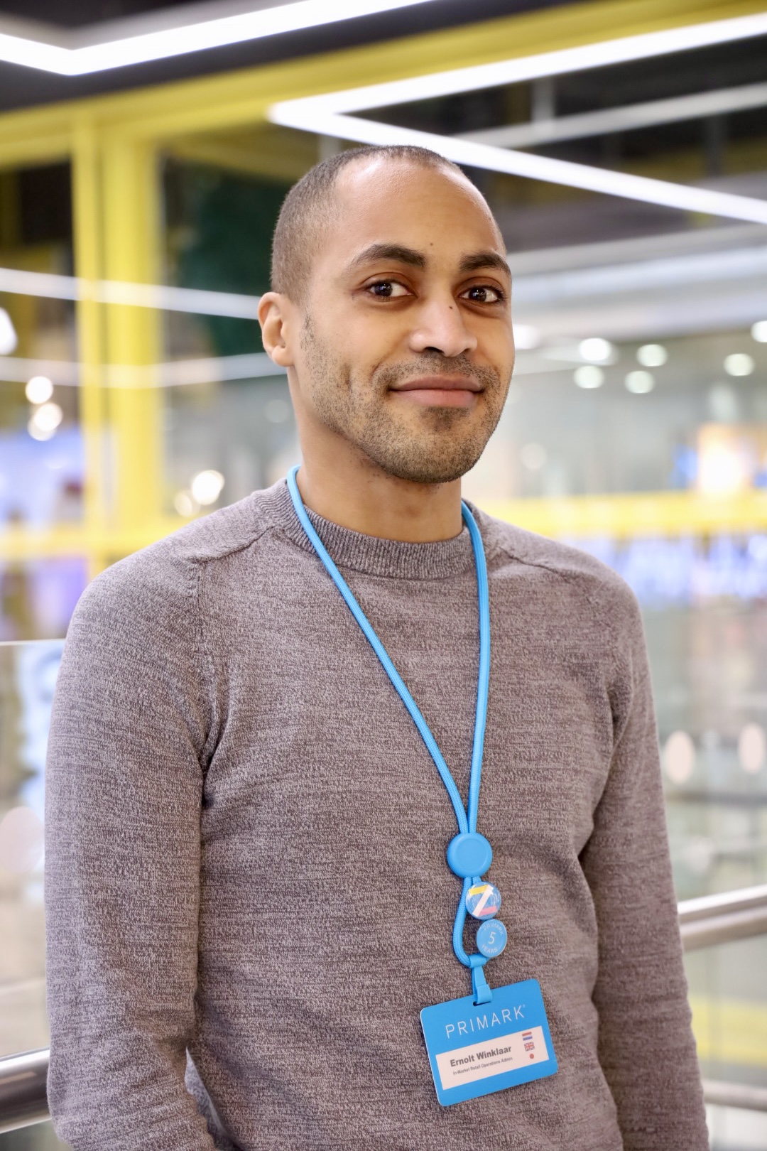 Colleague smiling at camera in store