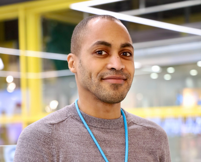 Colleague smiling at camera in store