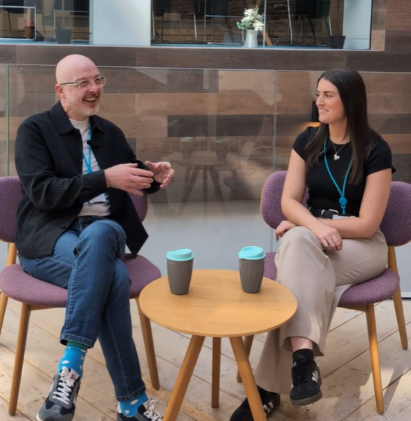 Colleagues sitting down talking in head office