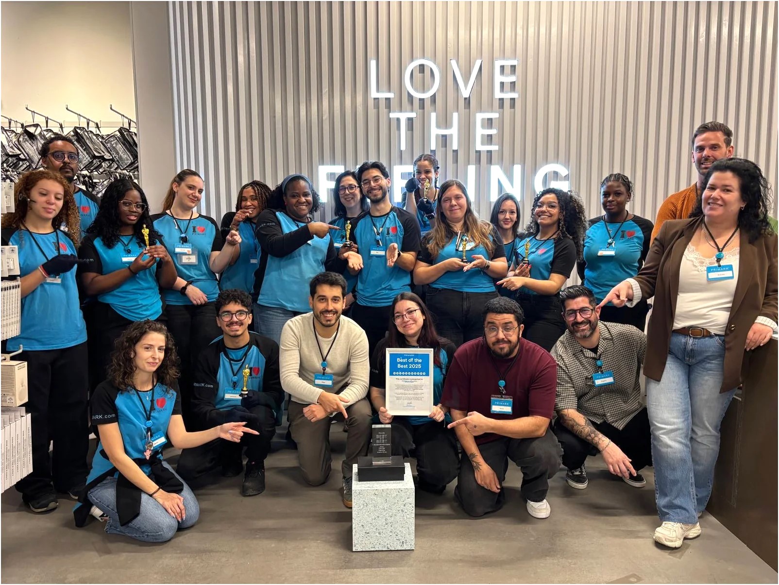 Colleagues in store celebrating an award together