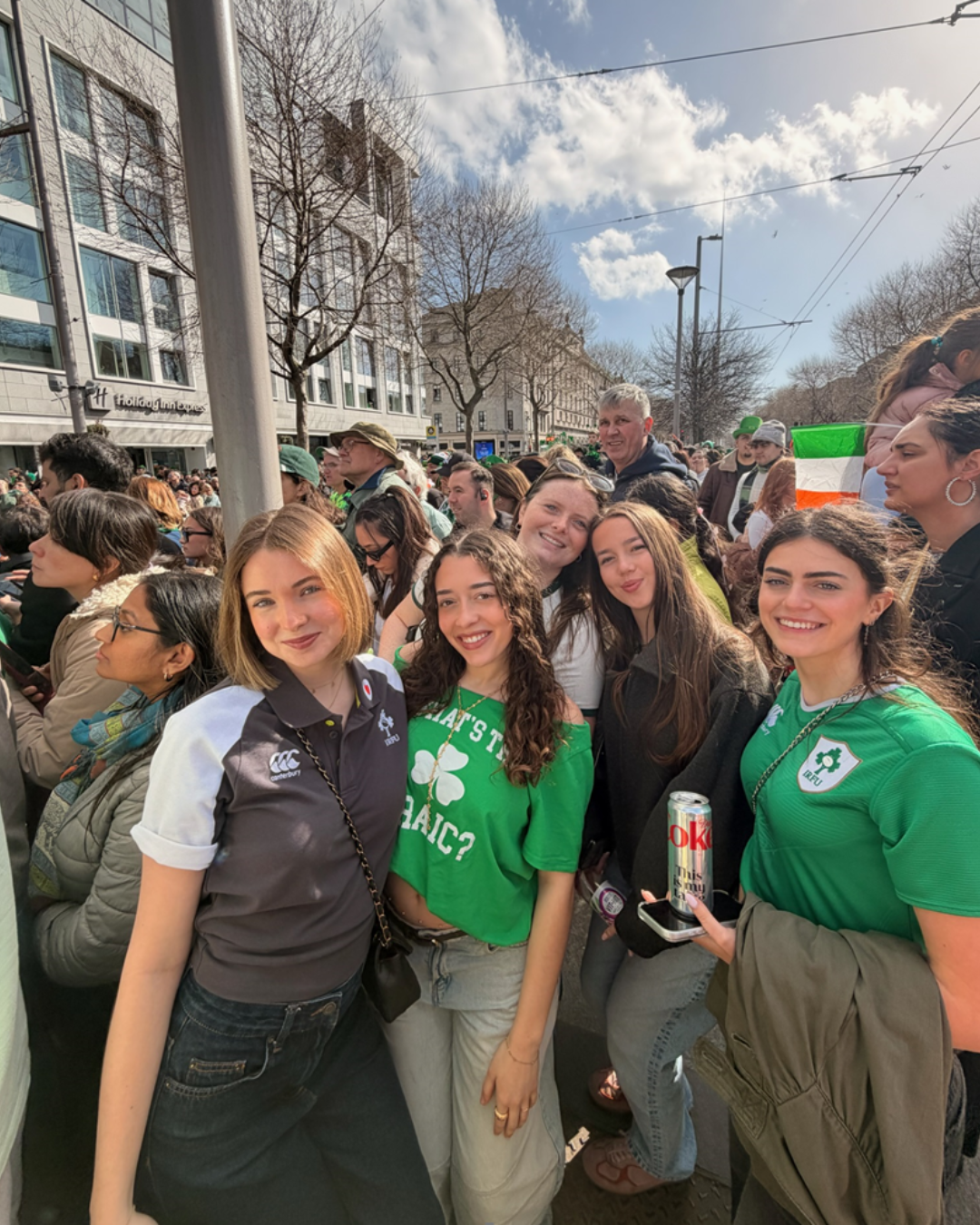 Five females standing together and smiling at St Patricks Day parade in Dublin