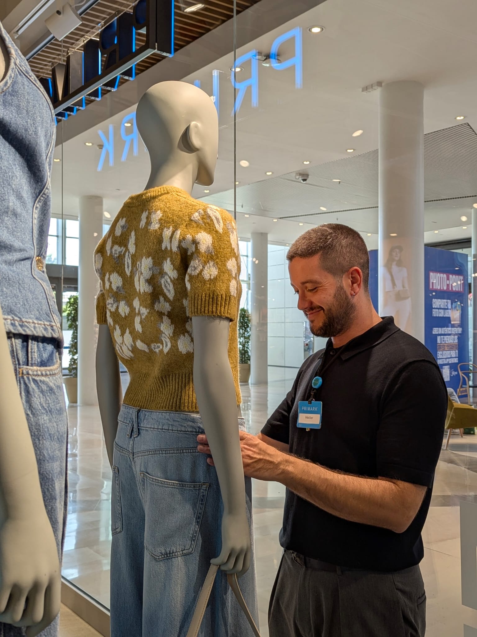 Colleague dressing a mannequin in store