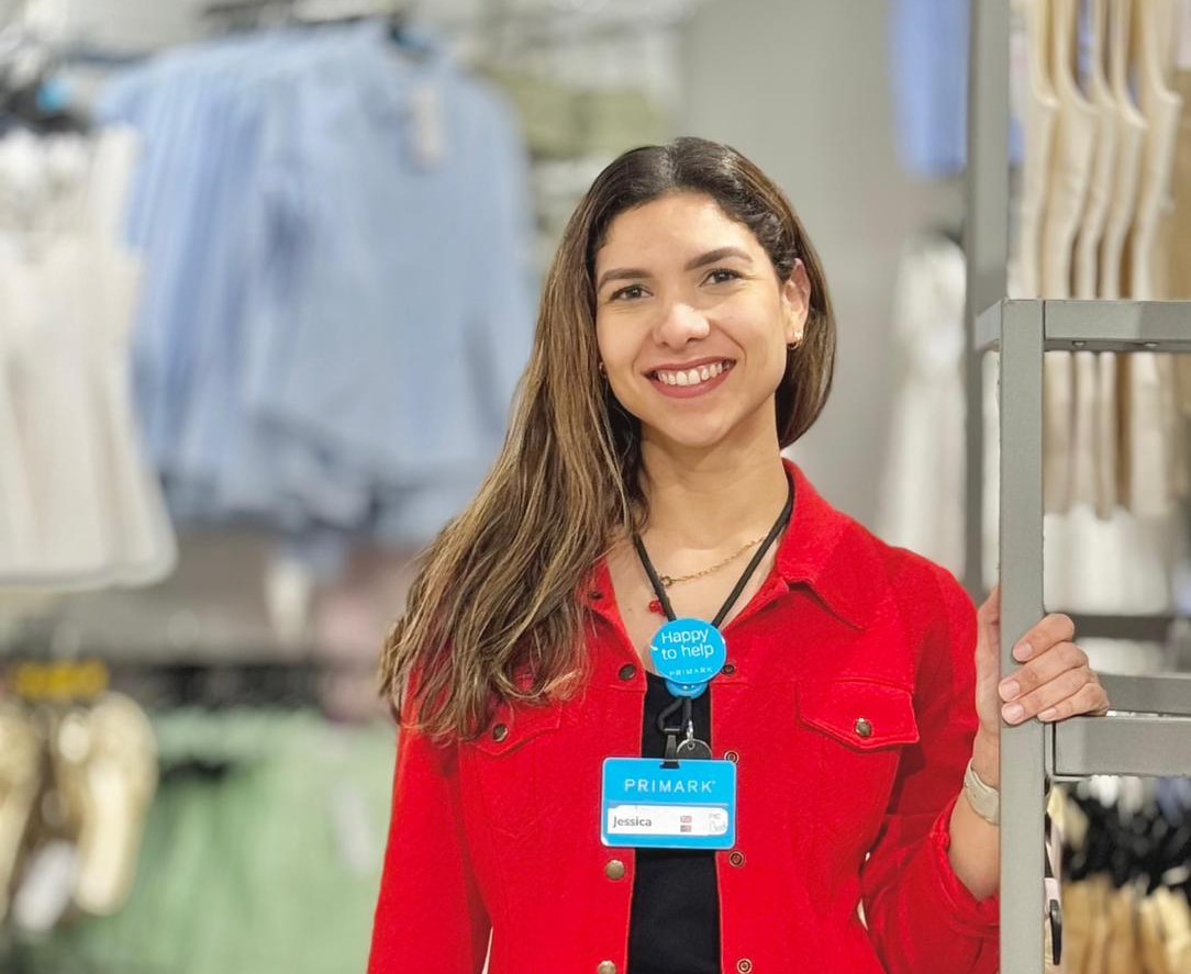 Colleague smiling in a Primark store