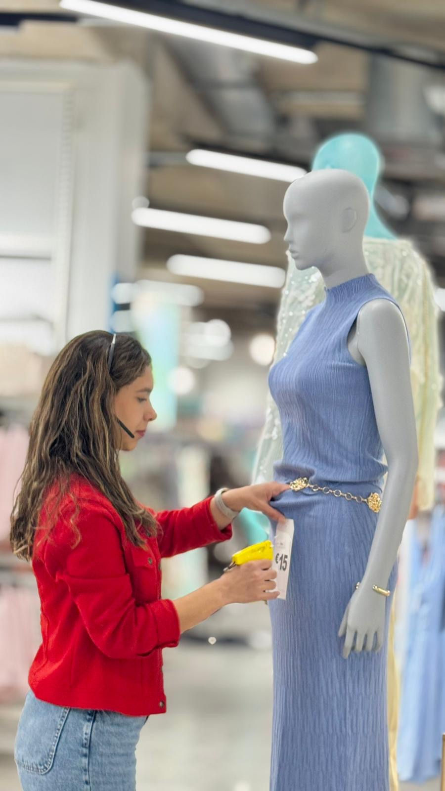 Colleague dressing a mannequin in store