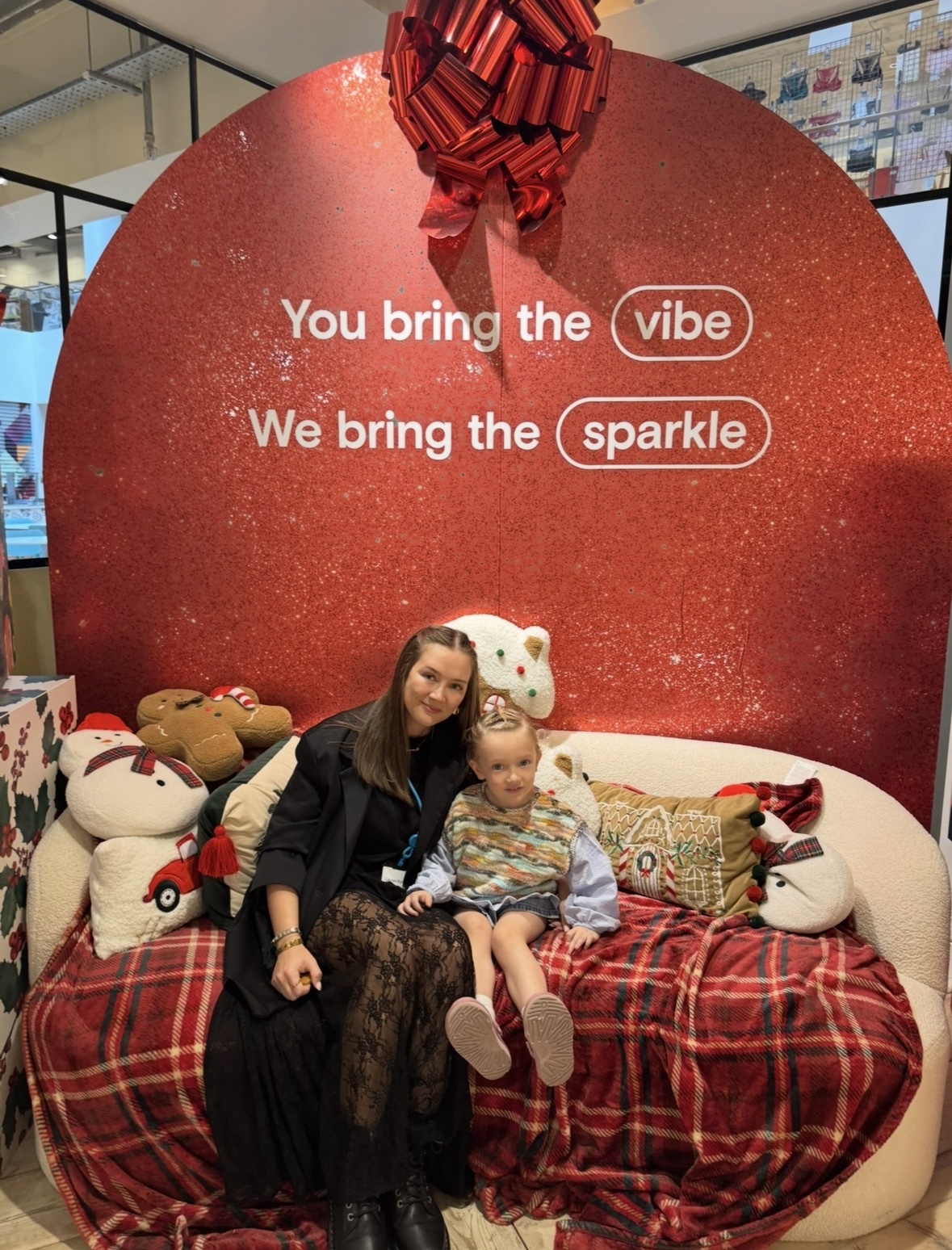 Female colleague sitting down with her daughter at a Primark Christmas party
