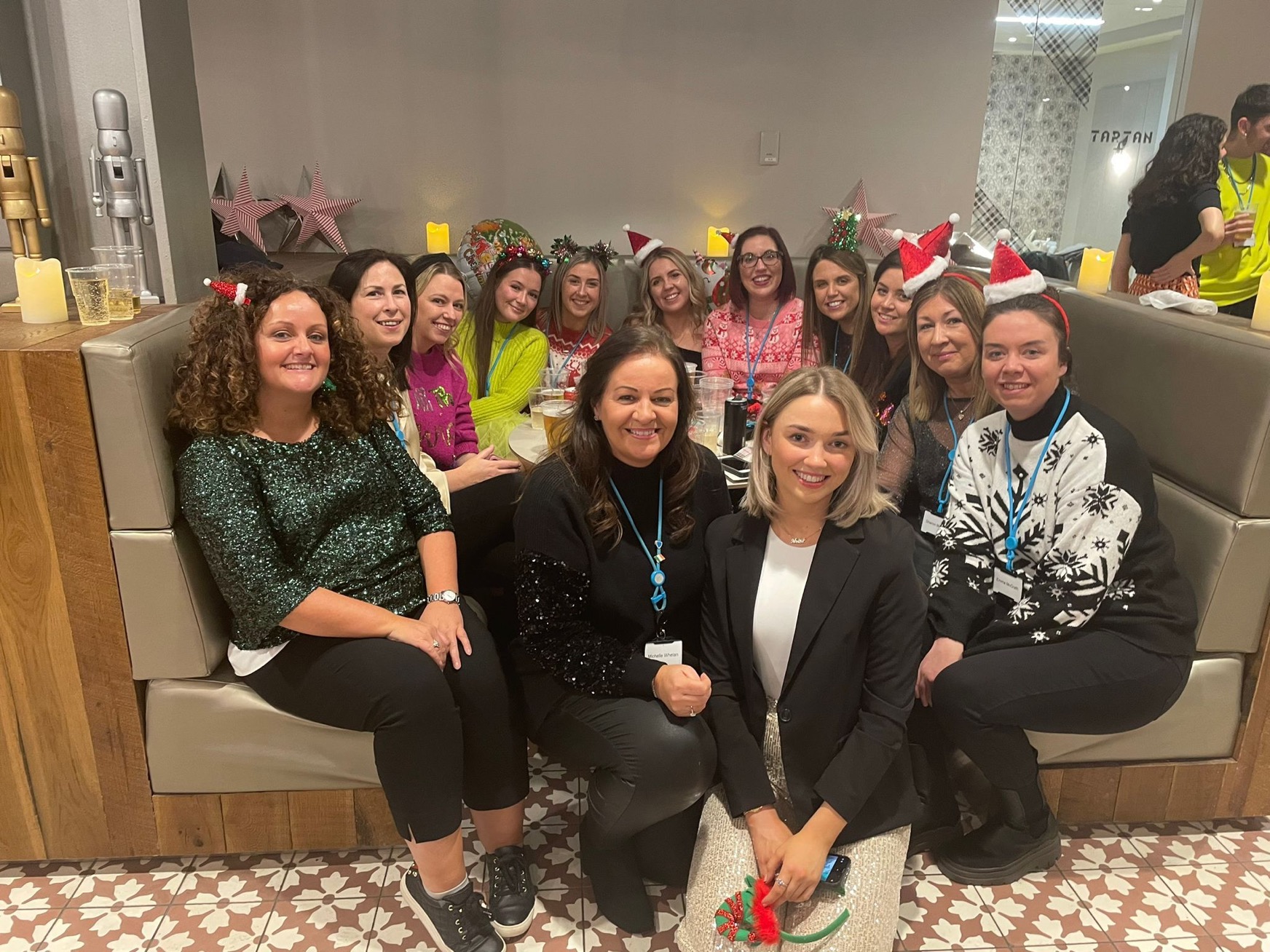 Group of colleagues smiling together at a Primark office Christmas party