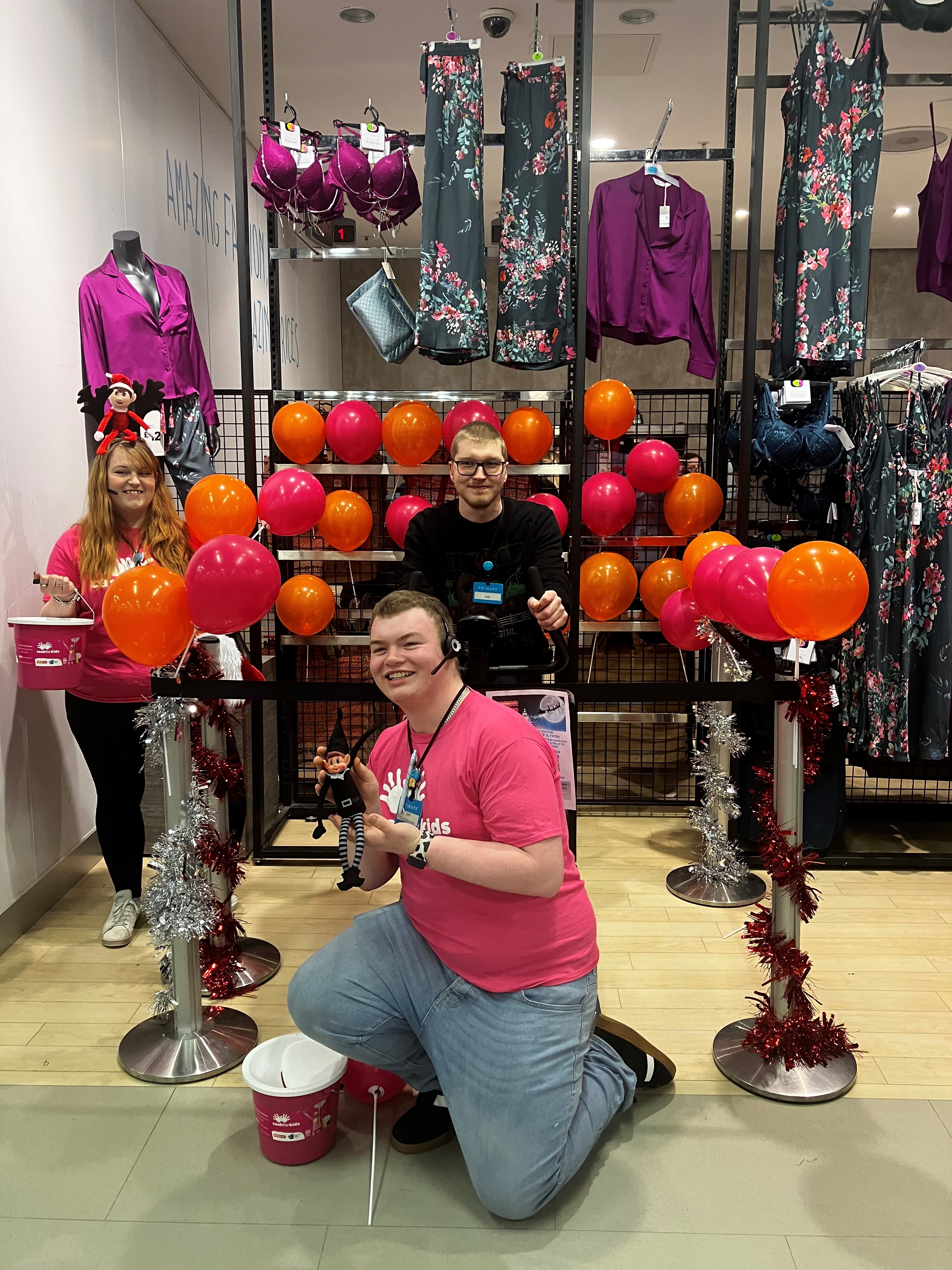 Colleagues standing together raising money for charity