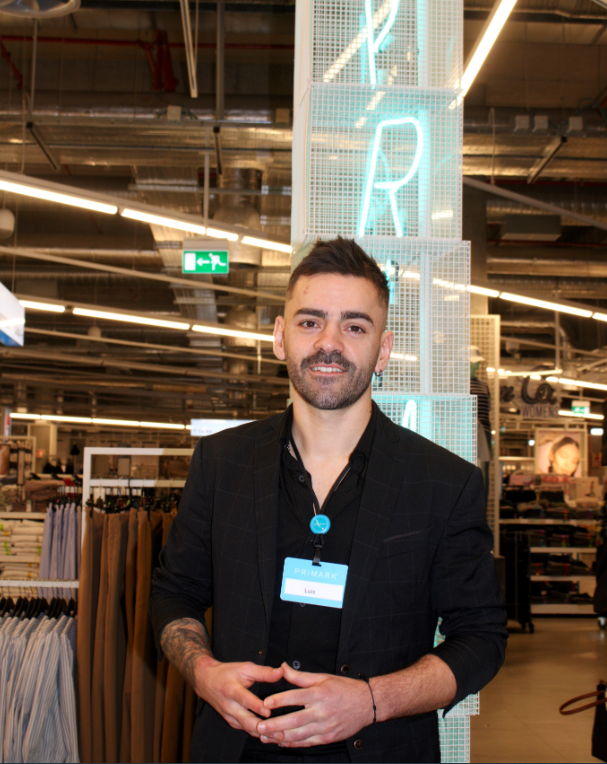 Colleague smiling at camera in store
