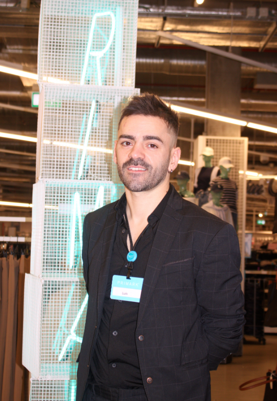 Colleague smiling at camera in store