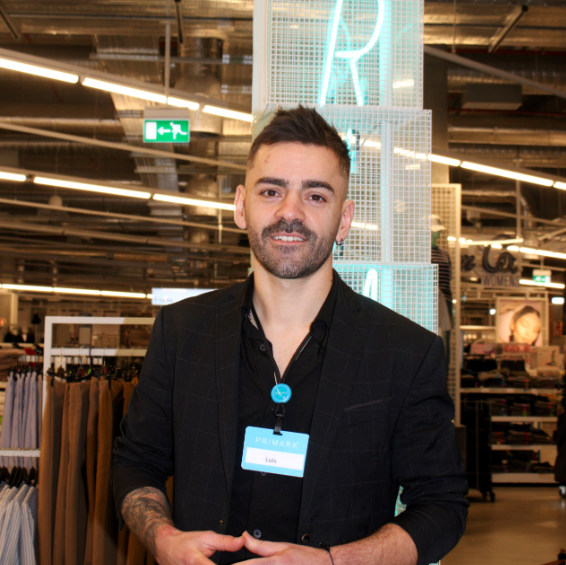 Colleague smiling at camera in store