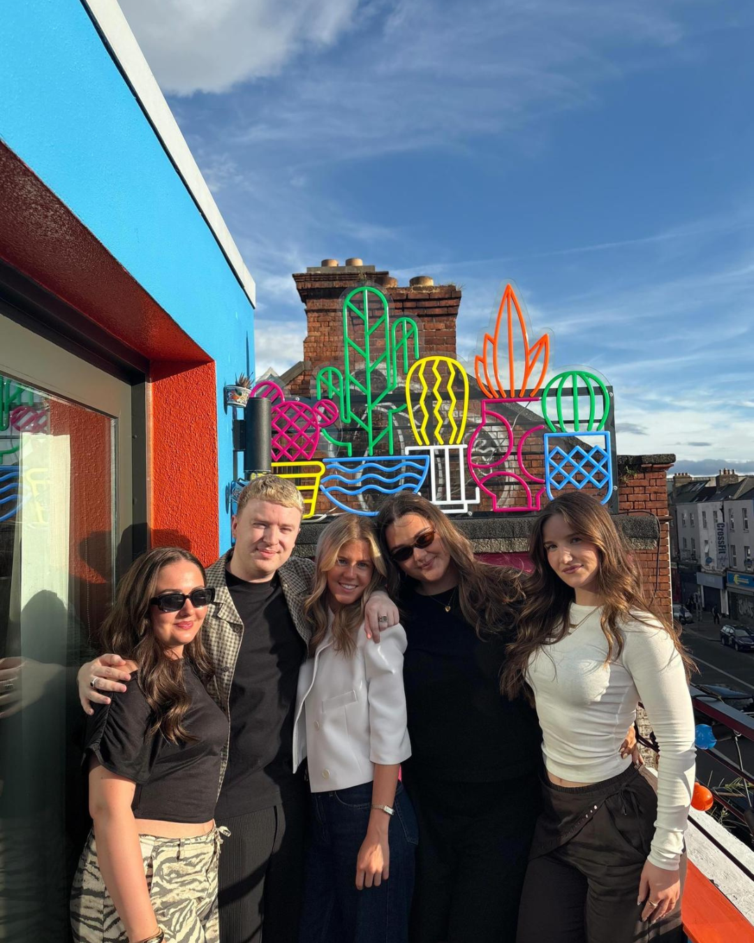 Five colleague standing together and smiling outdoors