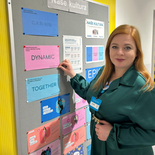 Colleague smiling at noticeboard