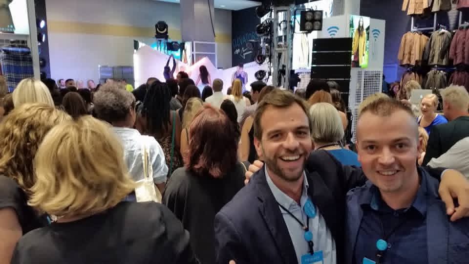 Colleagues standing together smiling at event