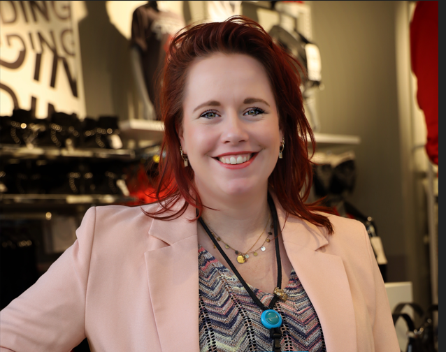 Colleague smiling with hand on hip in store