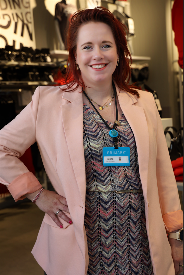 Colleague smiling with hand on hip in store