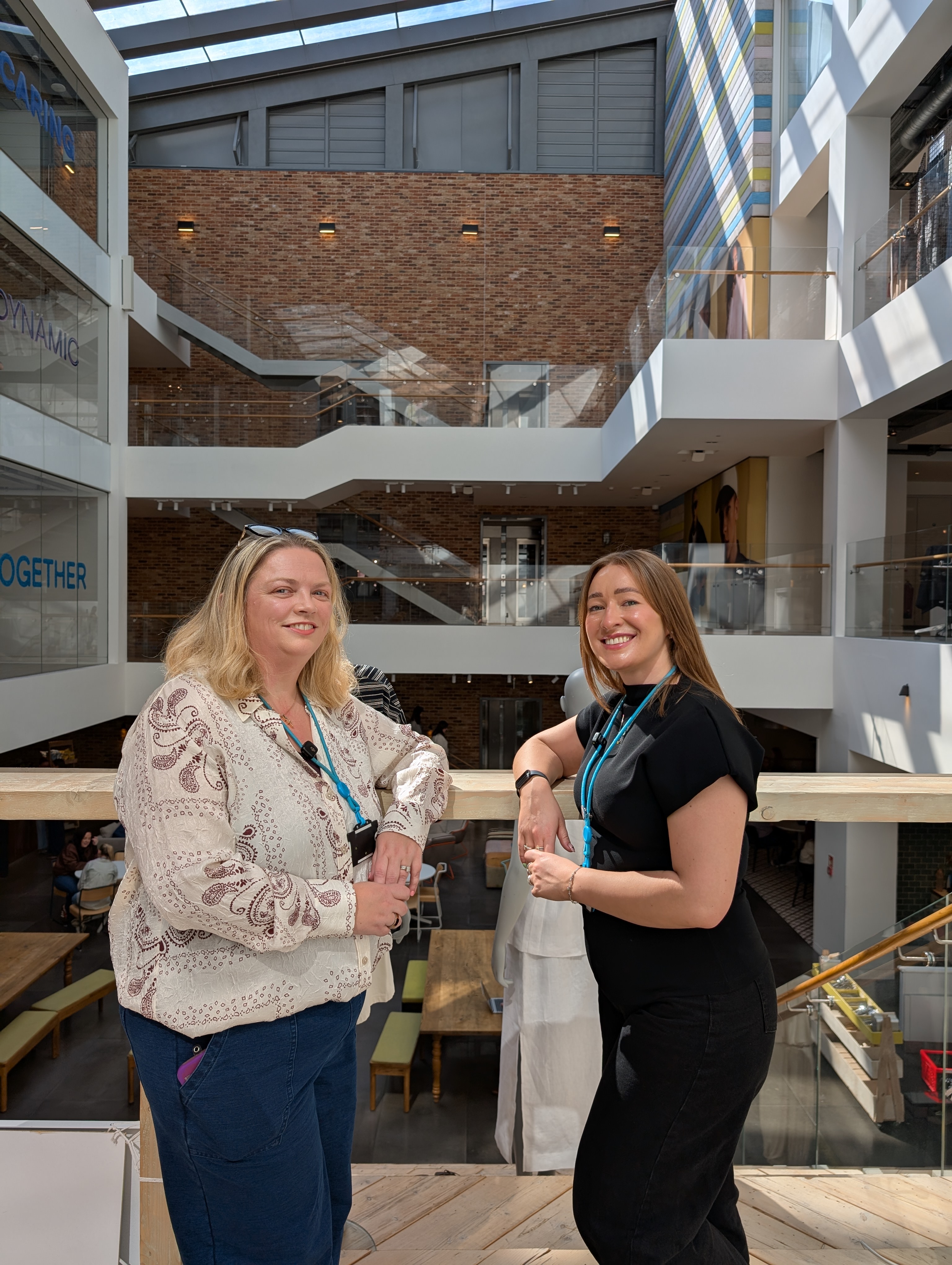 Two female colleagues standing together and smiling in Primark Dublin Head Office