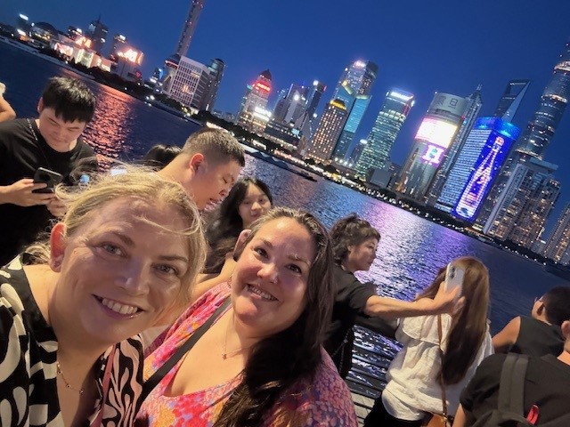 Two female colleagues smiling in a selfie photograph in China