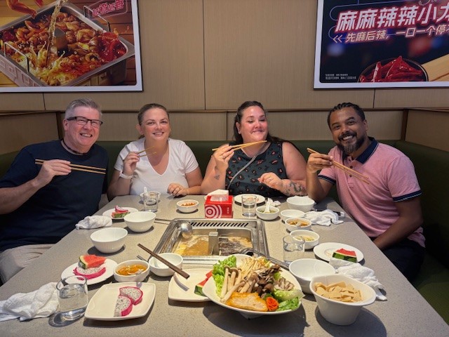 Four Primark colleagues eating together on business trip to China
