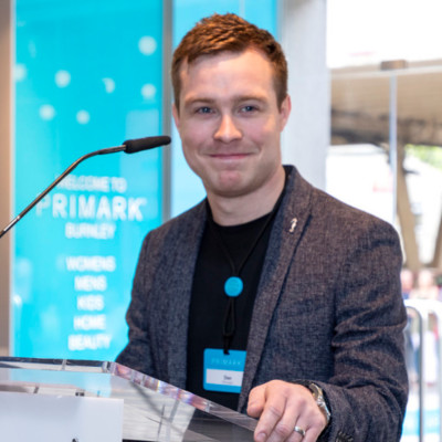Colleague standing at podium smiling