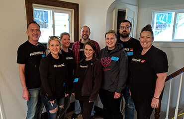 Toledo Accounting team members stand in the foyer of a Habitat for Humanity home