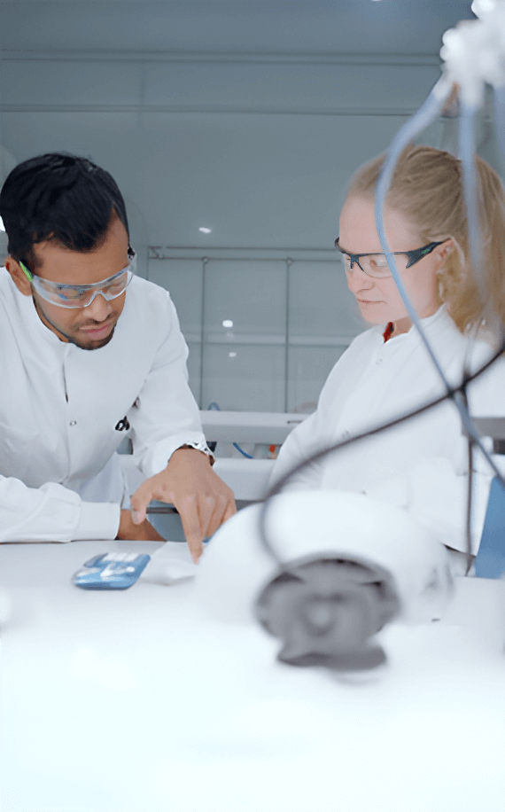 Two employees working together in a lab.