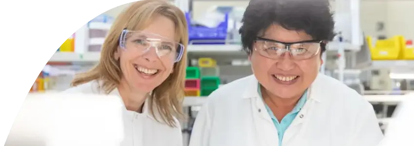 Two lab technicians smiling
