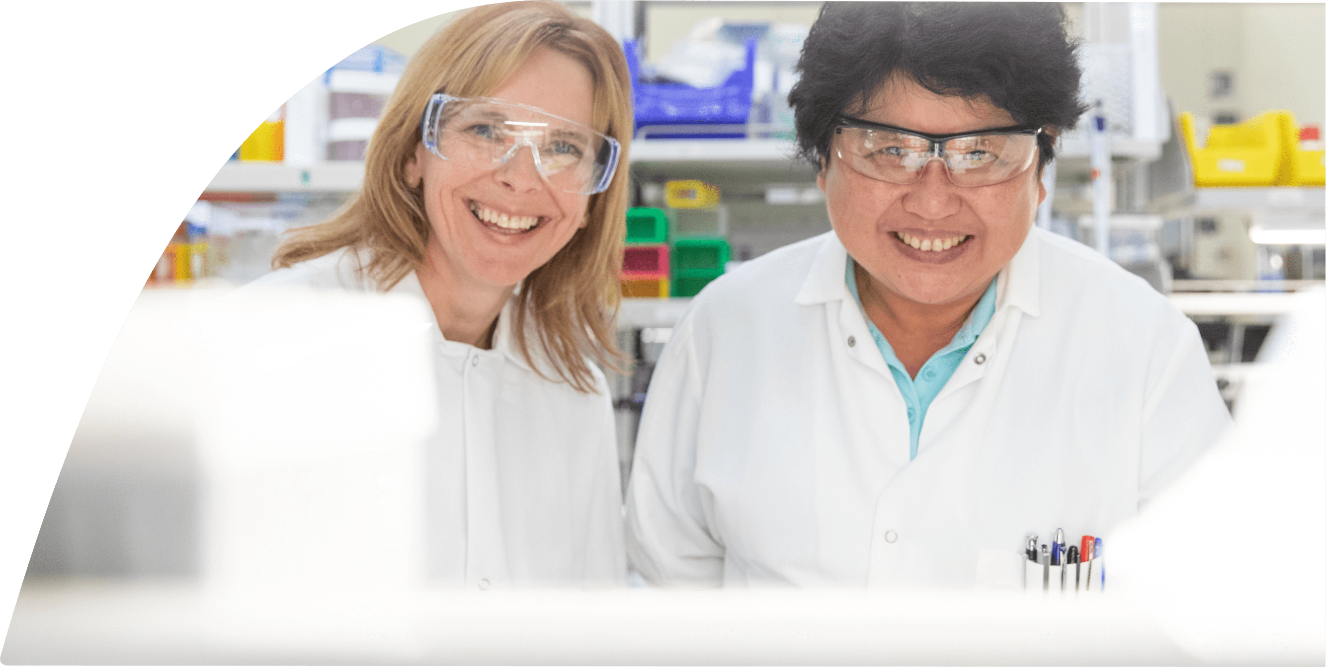 Two lab technicians smiling