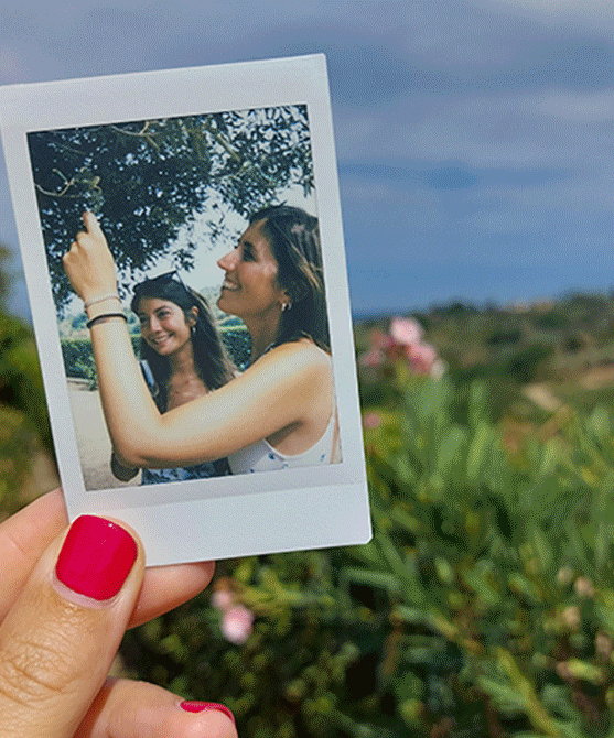 A carousel of pictures of Rebecca in their parents vineyard, her father producing wine, her holding a wine glas against the sun, a polaroid of her and a friend, her sitting by the water.
