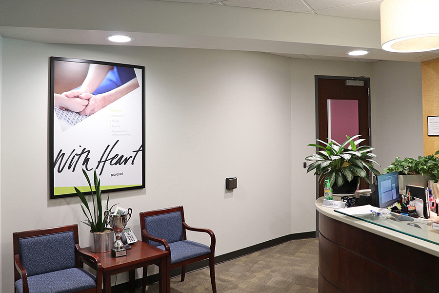 Image of Parexel's Durham office reception area with a poster stating with heart