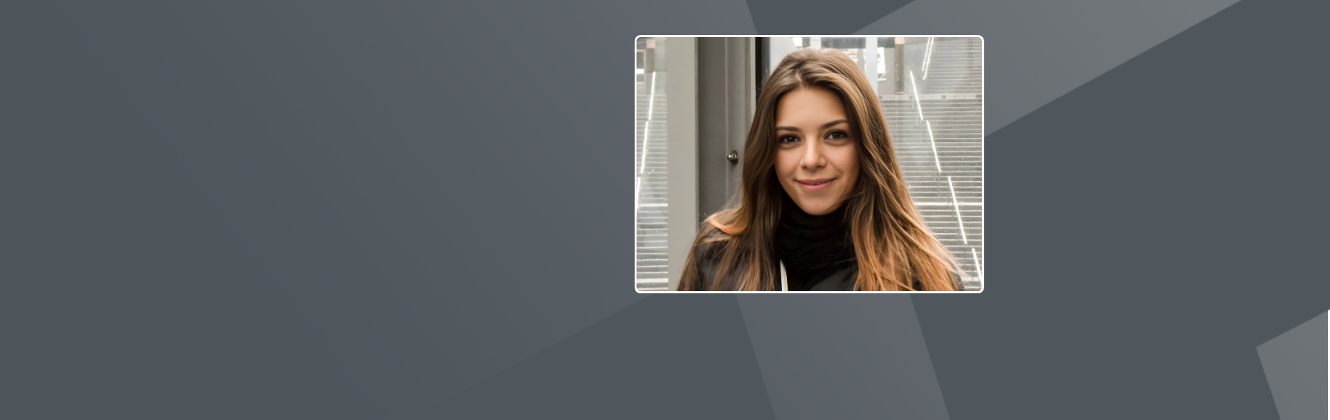 Adriane, a Brazilian woman. She wears a black turtleneck and jacket and has long brown hair. Behind her is a glass door and stairs, suggesting an urban or office setting.
