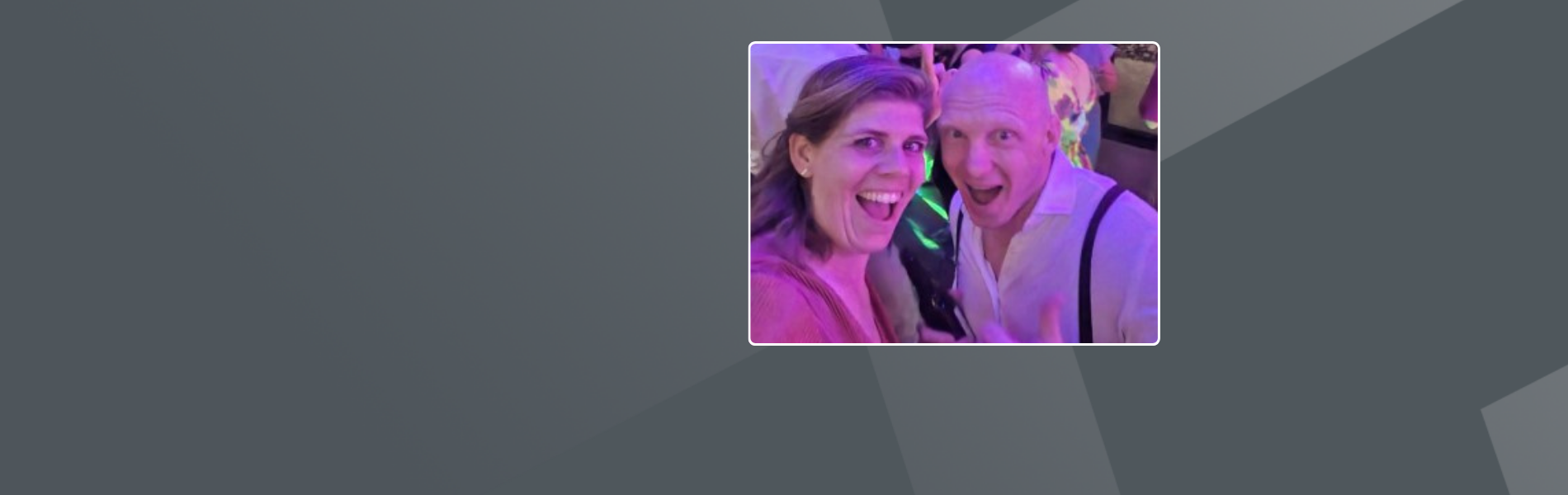 Marije, white female Dutch, with her husband looking happy on a dancefloor, the light is purple.