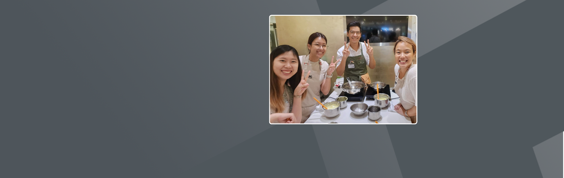 Theodora with several colleagues at a team cooking event. They all look at the camera smiling and some show the peace sign with their hands.