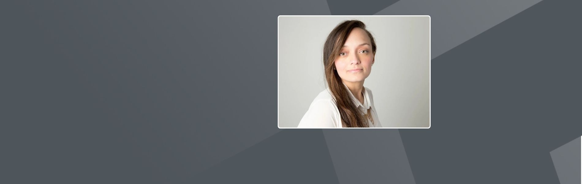 Diana, a Columbian woman with long brown hair is wearing a white blouse. She is looking directly at the camera with a subtle smile and warm expression. It's a professional headshot with natural lighting against a neutral background.