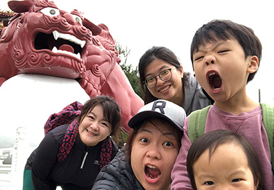 Joy Lin, Senior Director of Statistical Programming, is with her young children and colleague outside for a walk.