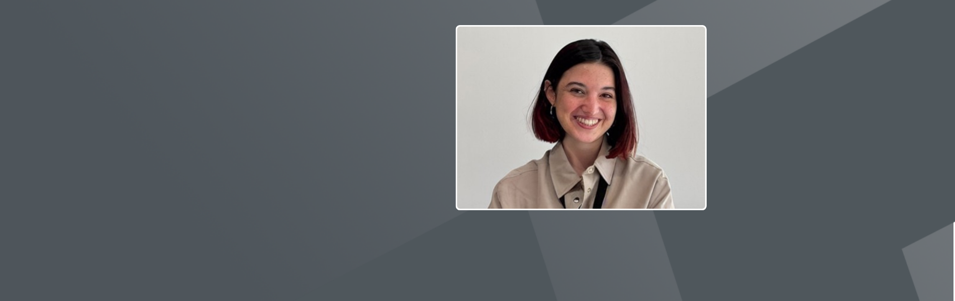Mercedes, with short brown hair and wearing a tan colored collared shirt, smiling at the camera.