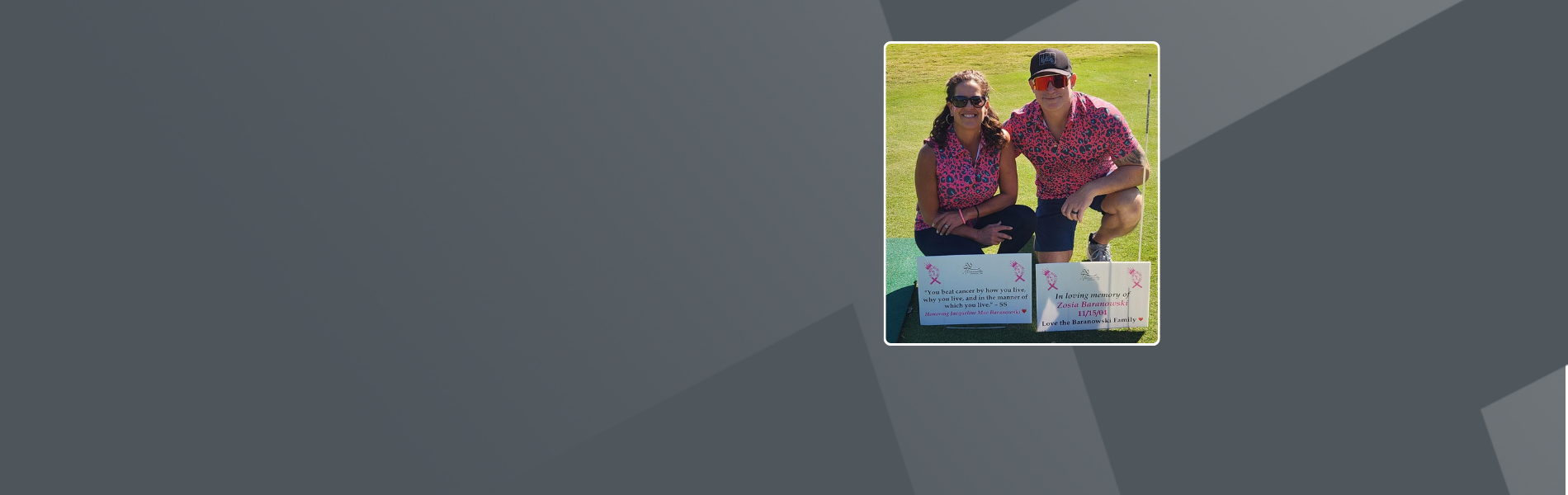 Ryan Baranowski and wife kneeling on golf course in matching pink leopard print outfits with memorial signs honoring family members at cancer awareness charity event.