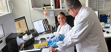 Rotating images of early phase employees working with patients, in labs, and group images.