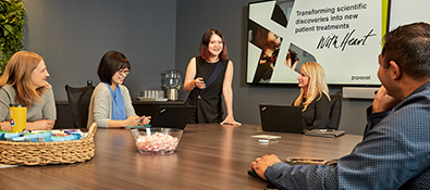 Image of several Parexel employees working in a conference room.