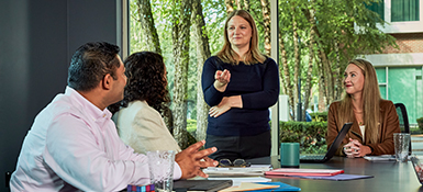 Several employees working in a conference room