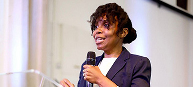 Xoli, a female Black English, giving a presentation