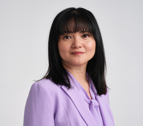 Jo, a Chinese American woman. She's wearing a stylish purple jacket and straight long dark hair with fringes.