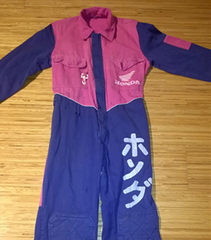 Anne's overall from her job at the Motorcycle Repair Shop. It's pink-blue and has a Honda logo.