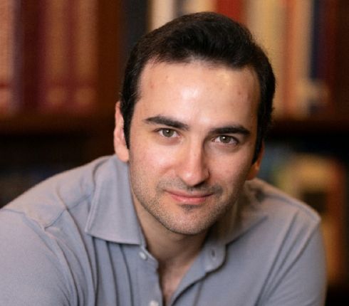 Aneiss Ghodsi, brown hair, wearing a gray buttoned up shirt