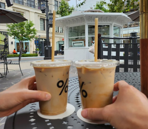 Inhye and her husband, Kiwan each holding a cup of coffee.