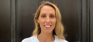 Jennifer smiling, blonde hair, wearing white shirt