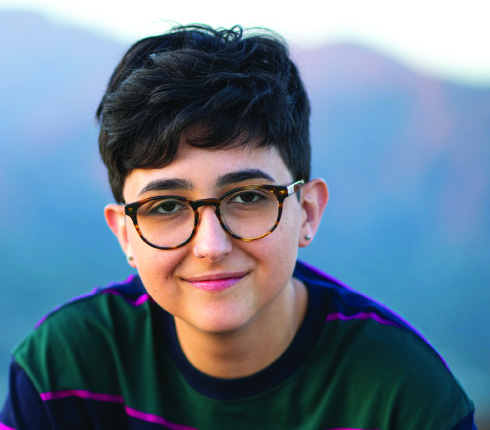 Parexel's "Discussions on diversity - gender identity" cover picture is showing a young person with short hair and dark big glasses smiling at the camera