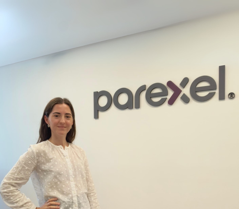 Sofia, smiling in front of the Parexel logo