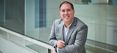 Steve Winitsky, an American male, VP-Technical of Regulatory Strategy, standing and smiling wearing a grey suit with a white button down.