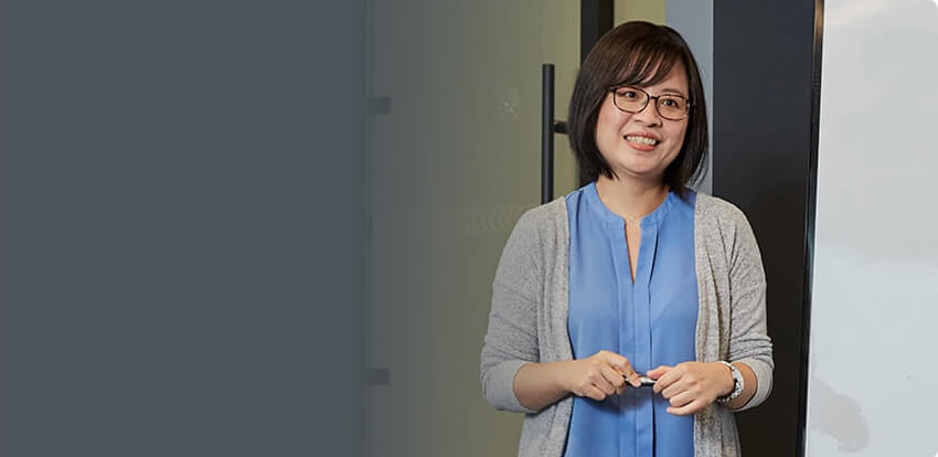 A woman presenting in a conference room